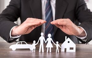 man in suit covering family, car and house model | hoa insurance coverage