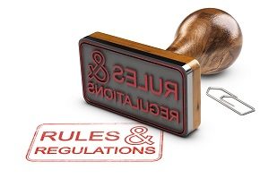 3D illustration of a rubber stamp and the text rules and regulations over white background | before moving in an HOA community