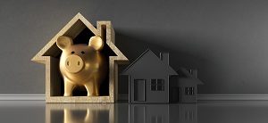 gold piggy bank inside wooden house model | benefits of townhome living