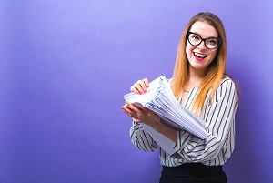 woman with a stack of documents on a solid background | hoa secretary