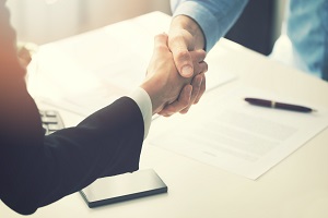men in suit handshake after partnership contract signing | contracting vendors
