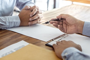 hand pointing at document with a pen | condominium association managers