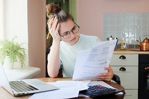 woman looking at document with a dismayed expression | hoa loan rates