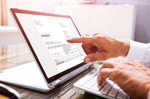 hand analyzing billing statement on tablet | paperless HOA