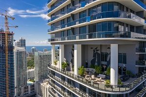 Aerial Miami Brickell highrise tower with recreational amenities area | condo welcome package