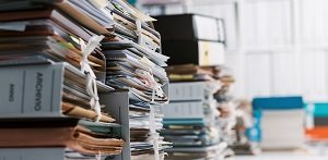 Stacks of paperwork in the office | condo welcome package