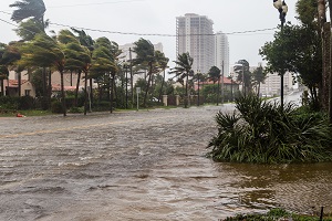 flooded street and strong wind during a storm | community association disaster preparedness