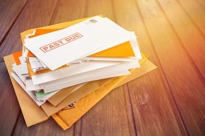 Pile of envelopes with overdue bills | benefits of d&o insurance for board members