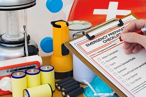 Hand completing Emergency Preparation List by Equipment | how to prepare for bad weather