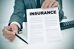 man in suit showing an insurance policy | hoa financial mistakes