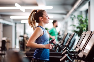 woman doing cardio workout in a fitness center | community amenities