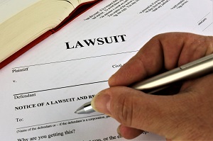 person filling out lawsuit form | enforcing homeowners association rules