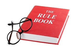 red Rule Book with reading glasses besides it | how to be a good treasurer for an organization