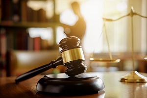 gavel and scale with a man in the background | selective enforcement definition