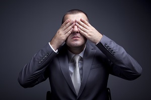 man in suit covering his eyes with two hands | lack of communication in HOA