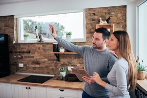 Couple talking about home renovation ideas | hoa renovation rules