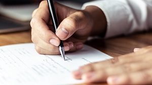 man signing a document | hoa pet restrictions