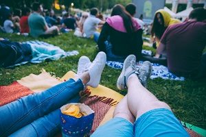 people watching movie in open air cinema in city park | ideas for HOA social events