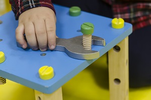 child playing wrench and bolt toys | playground safety
