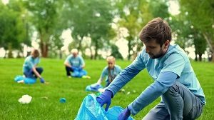 Male volunteer picking up litter | community pressure washing