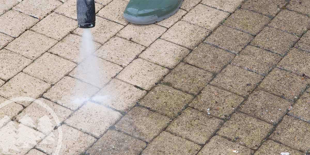 man pressure washing bricks | community pressure washing