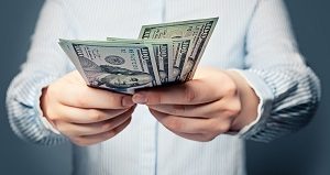 man holding and giving dollar bills | homeowners association reserve funds