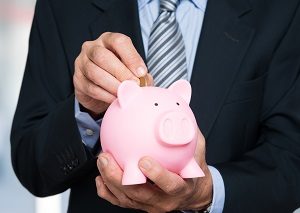 Man putting money in a piggy bank | hoa fees include