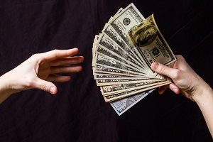 hands handing over cash | hoa accounting standards