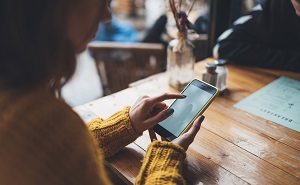 woman using a smartphone | newsletter for your HOA