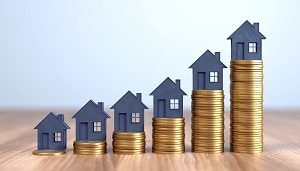 stack of coins in ascending order with paper houses | fund capital improvements