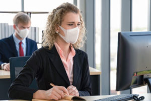 Employees working with face masks on | coronavirus and HOA responsibility