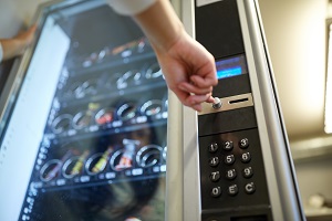 hand pushing button on vending machine operation panel | increase hoa cashflow