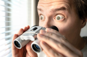 surprised man with binoculars. Curious guy with big eyes | homeowners association complaints